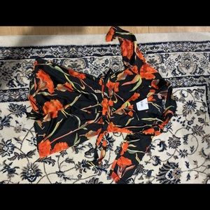 Satin romper. Zips in front, collared with belt.